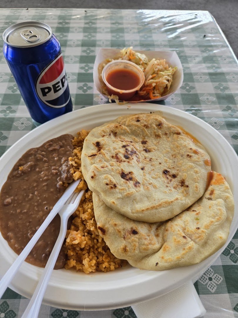 Pupusas and tacos served in a relaxed setting.